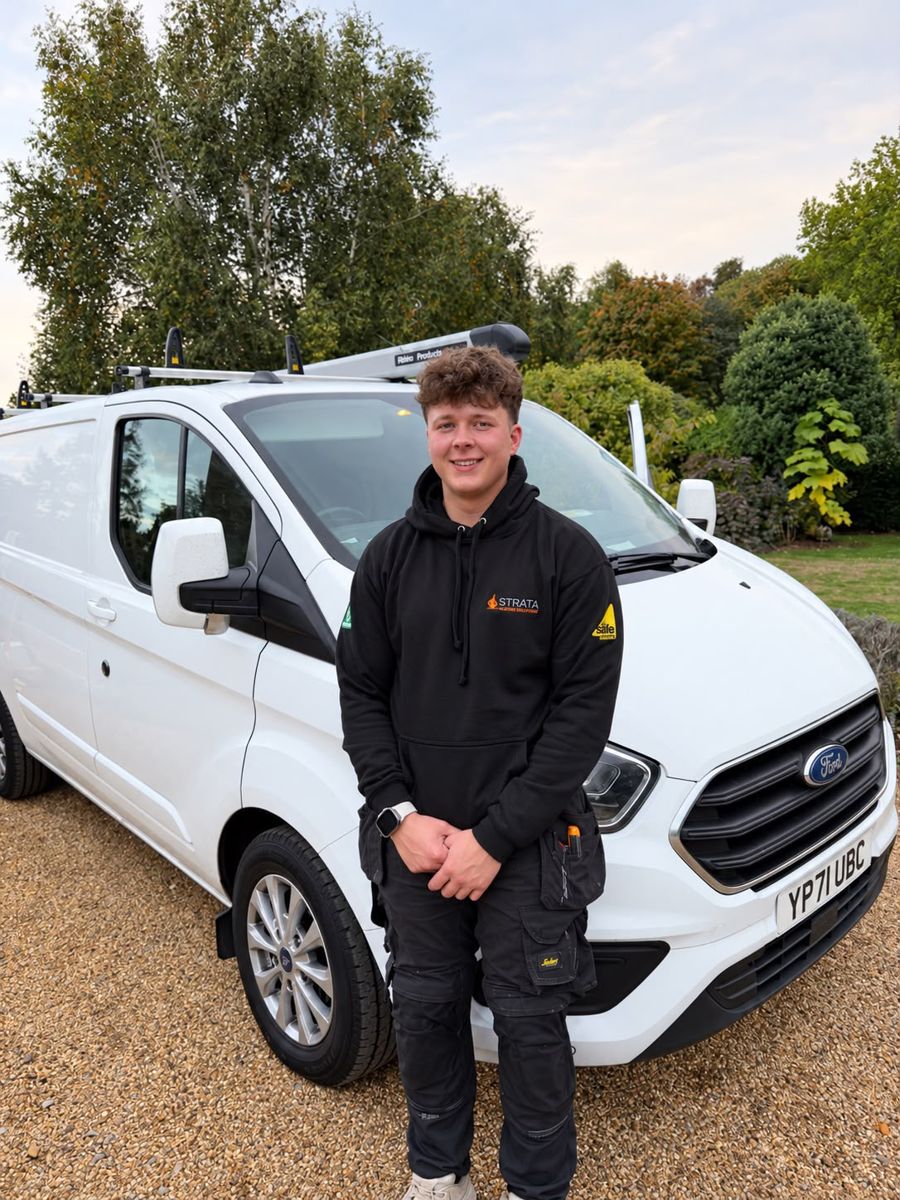 Strata Plumbing & Heating engineer standing in front of his white Ford Transit Custom van