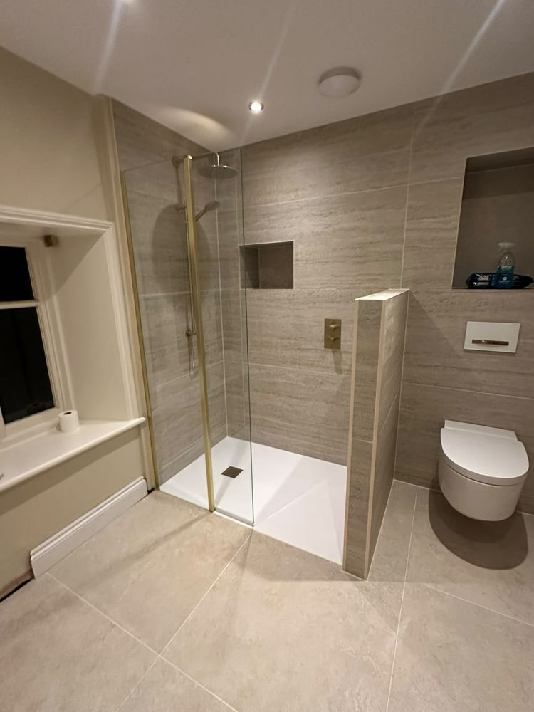 Walk-in shower with brushed brass fittings
