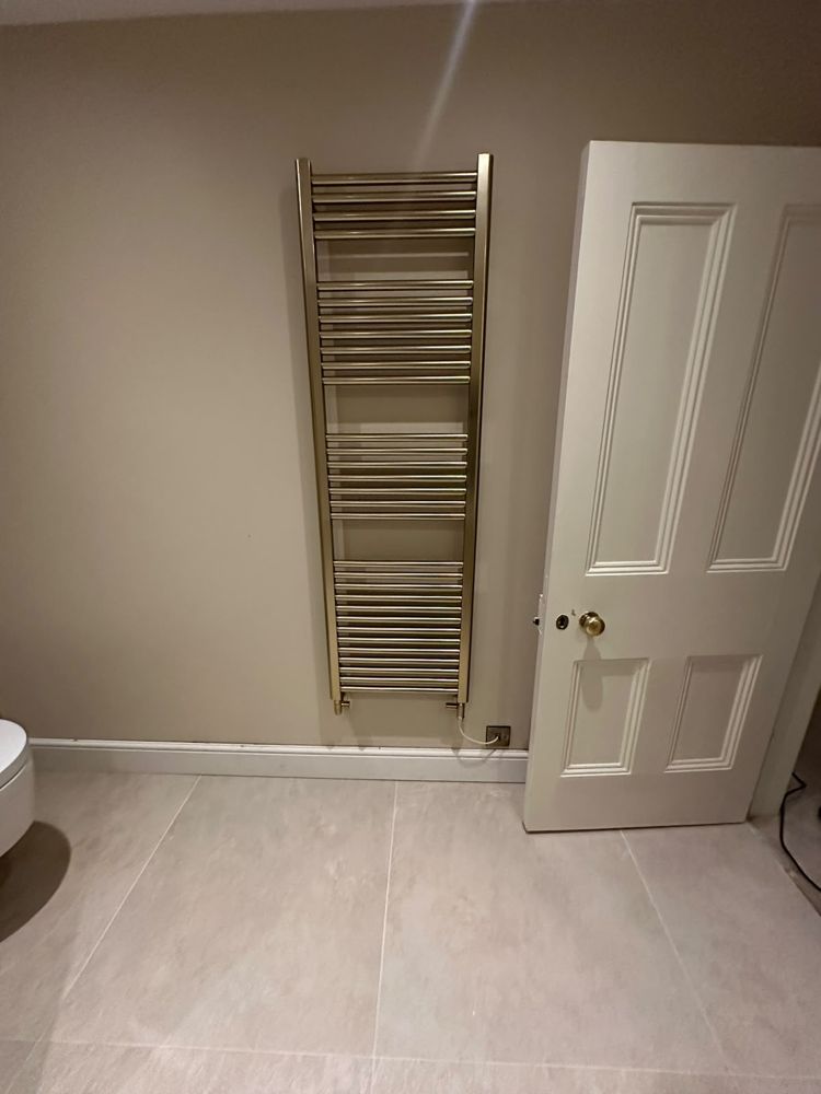 Tall brushed brass heated towel rail