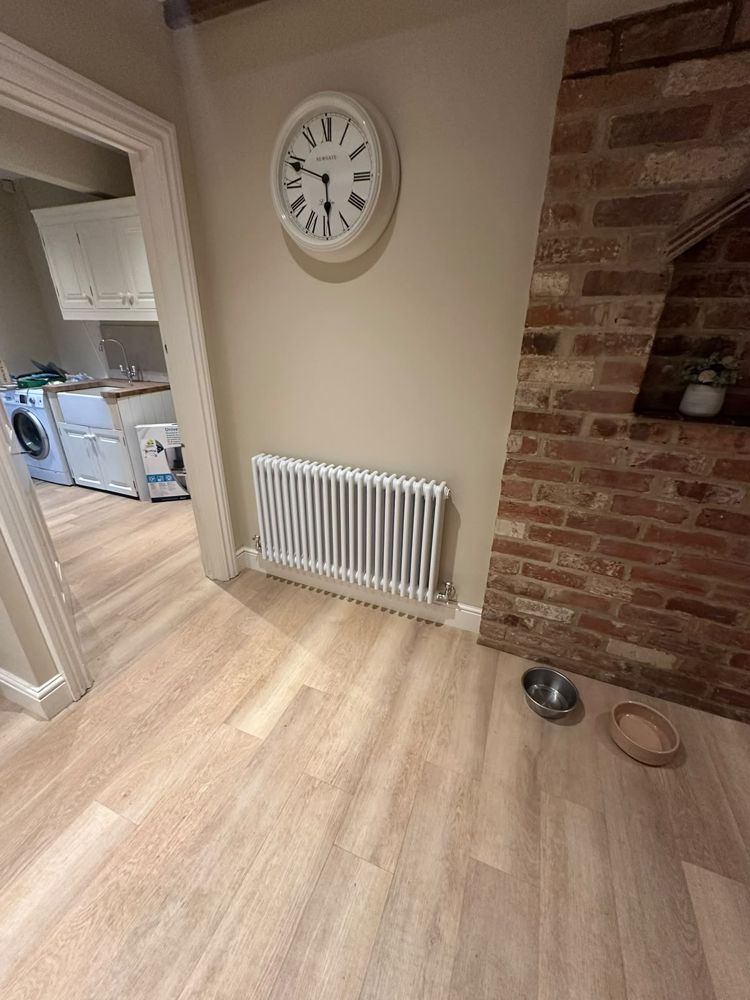White column radiator fitted in a hallway