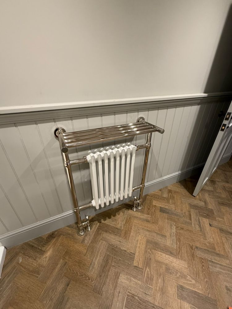 Traditional nickel towel rail with a white column radiator